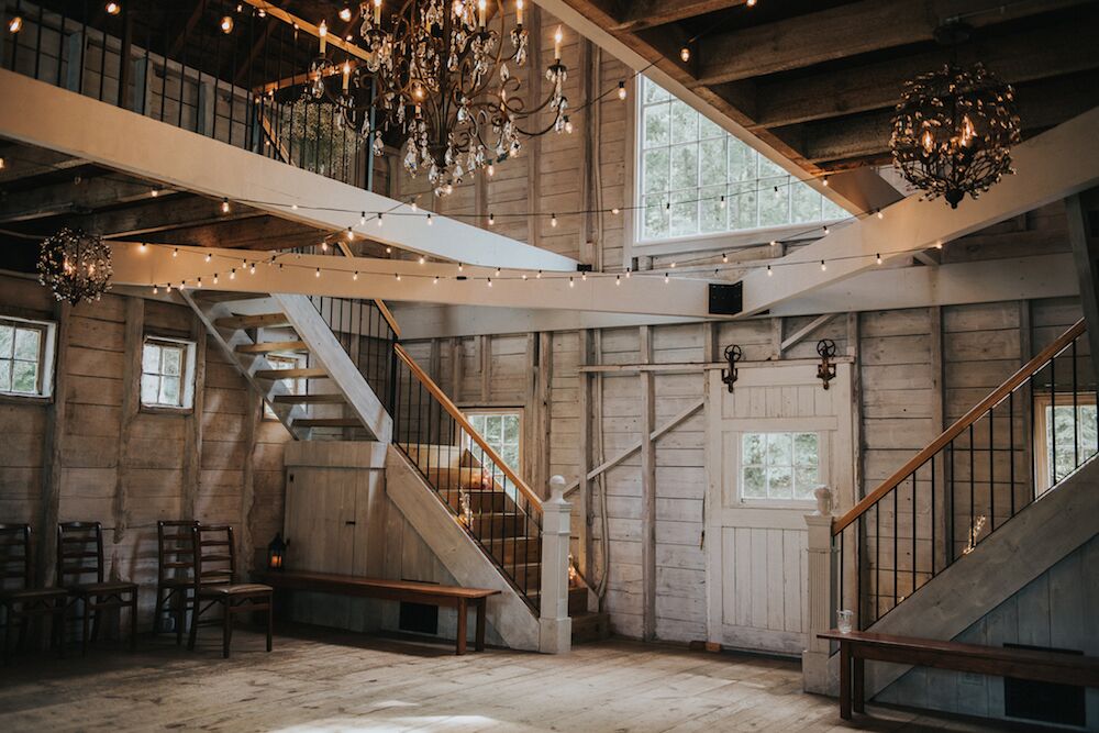 Whitewashed wedding barn with hanging lights